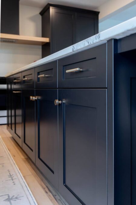 Black shaker cabinet doors with warm metallic hardware by Crosby Fine Cabinetry Belle Plaine MN