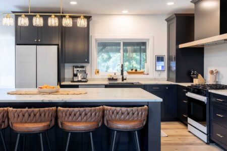 Custom black kitchen with oversized quartz island and seating in Carver, Minnesota by Crosby Fine Cabinetry Belle Plaine MN