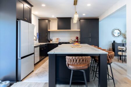 Custom black kitchen with large quartz island in Carver, Minnesota by Crosby Fine Cabinetry Belle Plaine MN