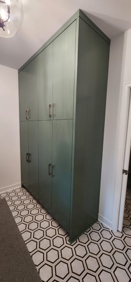 painted green tall cabinetry storage by Crosby Fine Cabinetry Belle Plaine MN