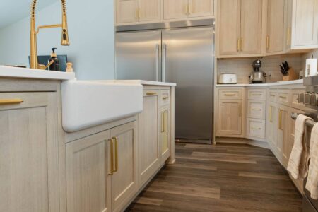 white farmhouse sink in custom kitchen island by Crosby Fine Cabinetry Belle Plaine MN