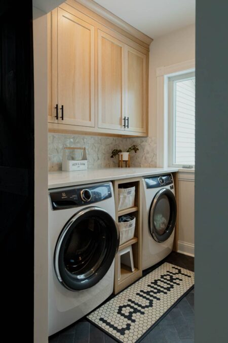 white oak inset custom cabinetry built around a washer and dryer by Crosby Fine Cabinetry Belle Plaine MN